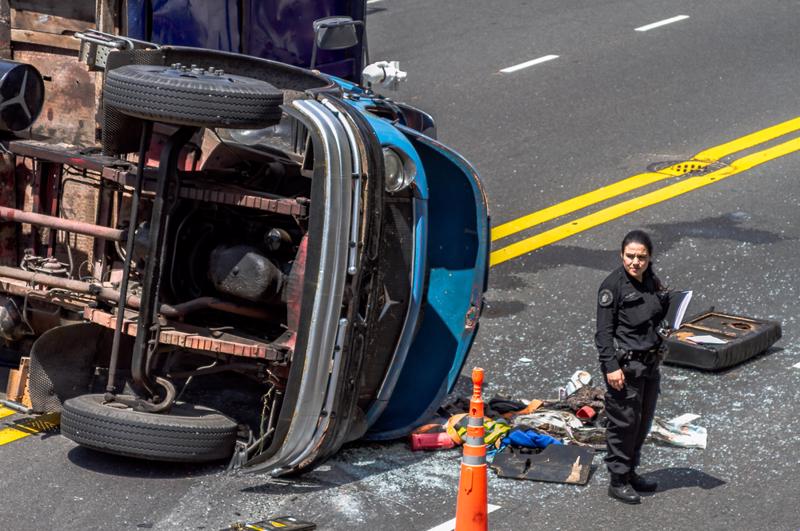 An officer of the law documenting a truck accident scene in Springdale, Arkansas