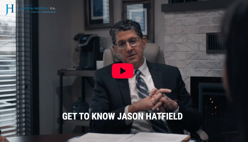 Home Get to know Jason Hatfield video screenshot, Jason Hatfield speaking at a meeting in his office.