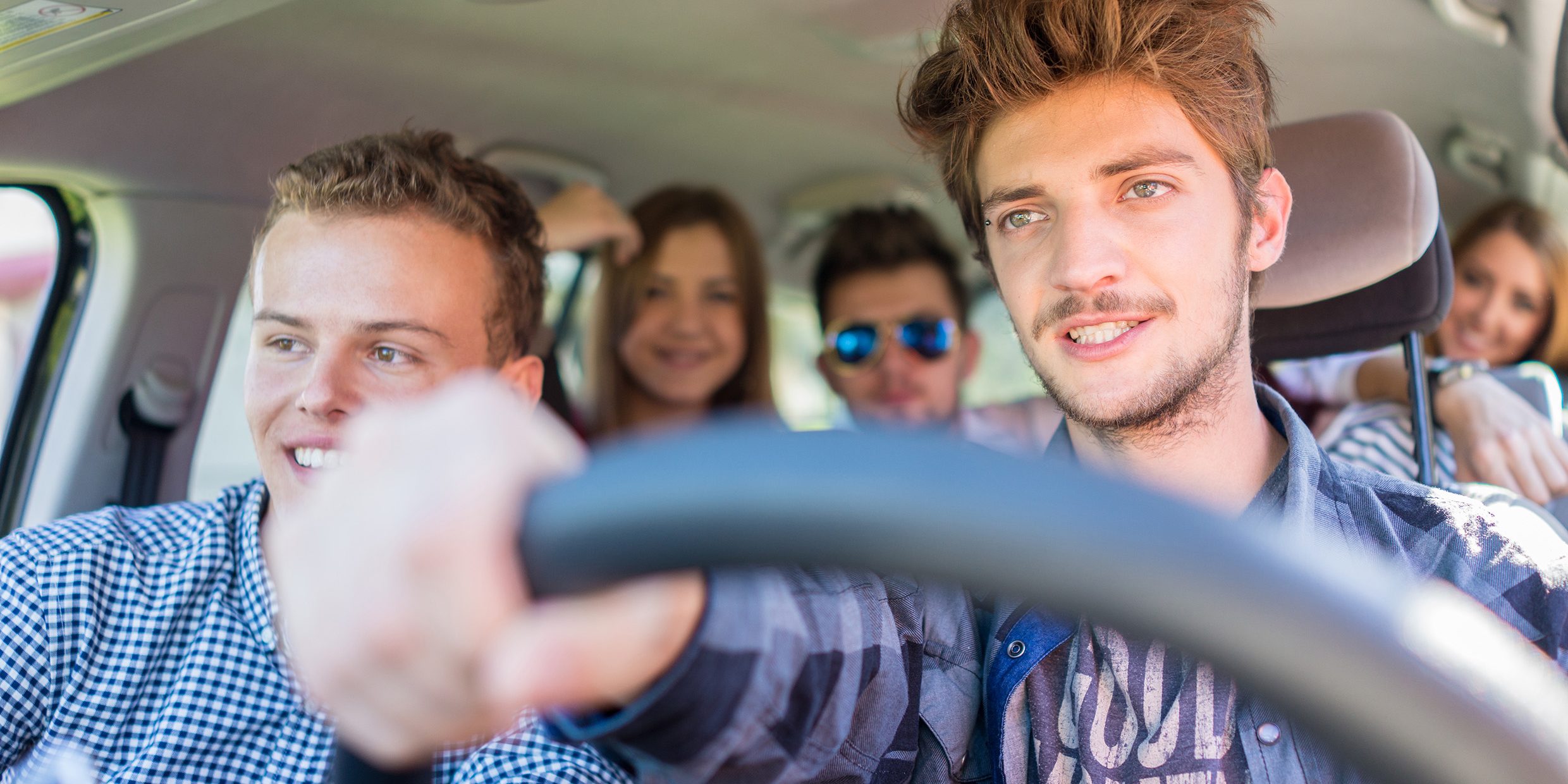 Teenagers in car on a road trip